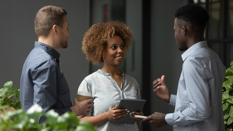 A group of three professionals talking