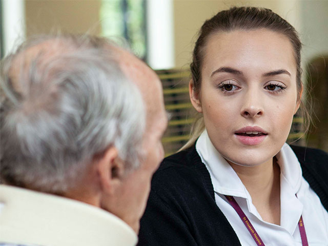 Professional talking to a person with MND