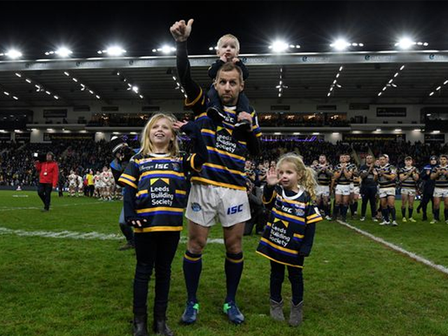 Rob Burrow and his three children in the rugby stadium 