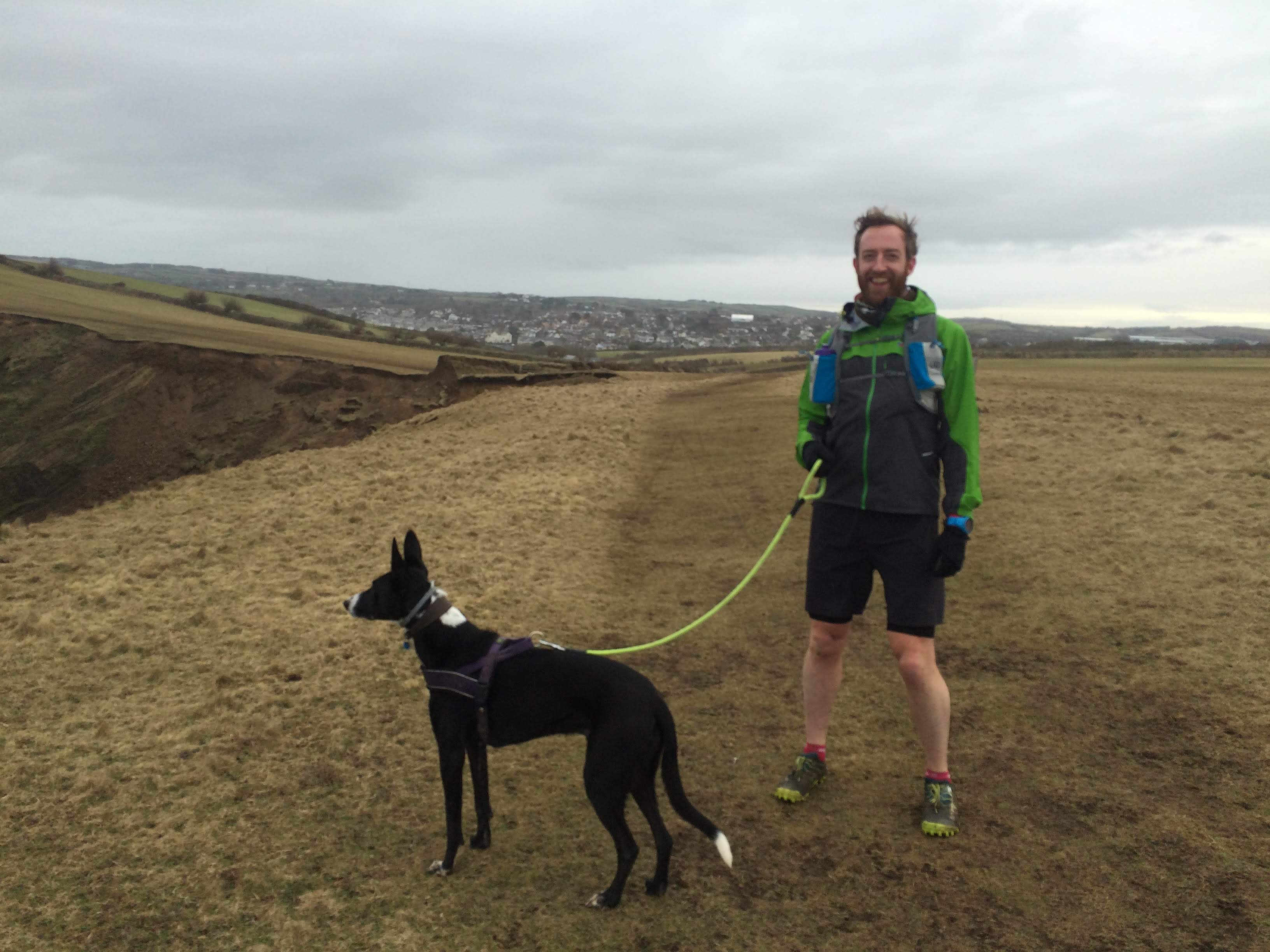 Alex walking his dog in the countryside