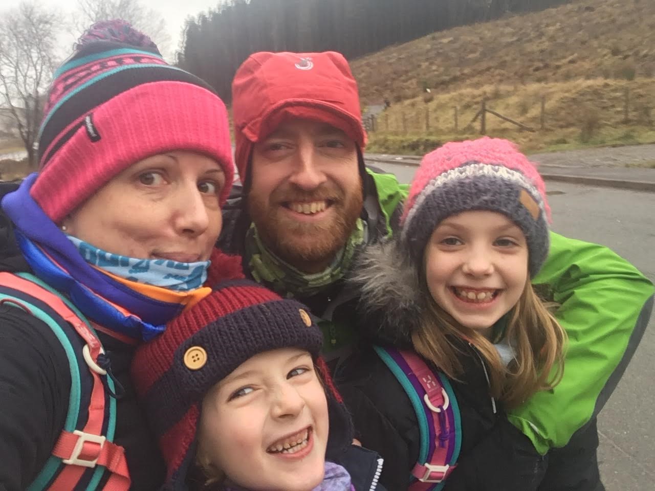 Alex and his family dressed in winter clothes, in the countryside