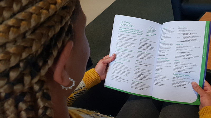 A woman reading a guide