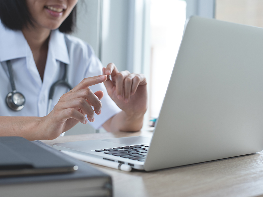 Health professional looking at her laptop screen