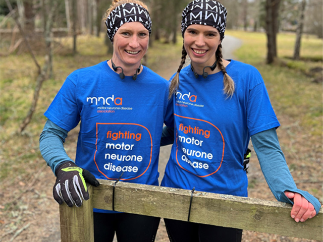 image of two people wearing mnda branded t-shirts