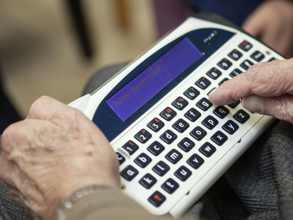 A person typing on a lightwriter