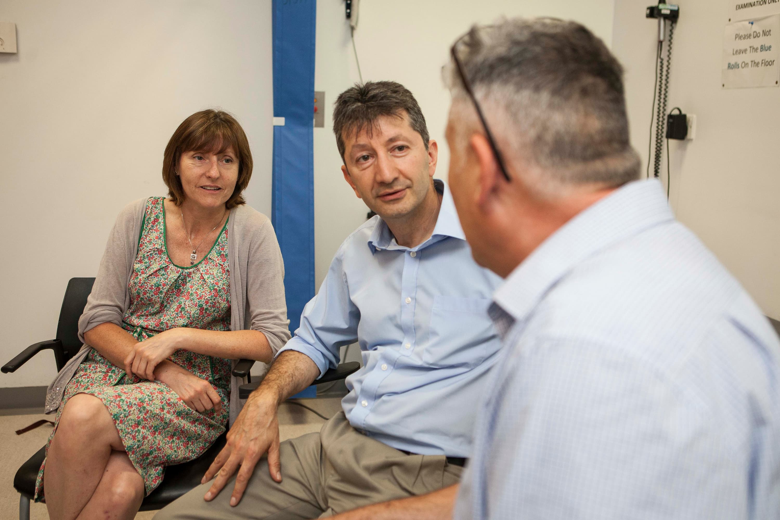 Ammar Al-Chalabi with patients in his clinic