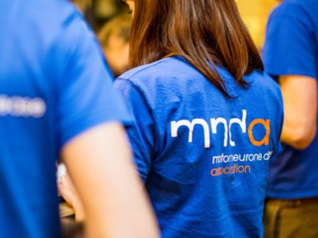 people wearing a MNDA logo t-shirt