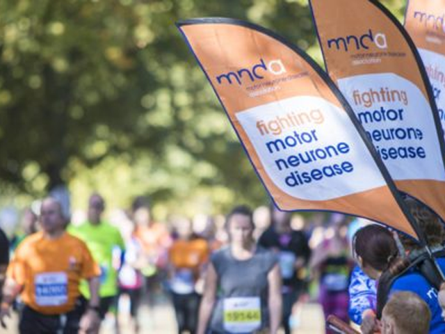 people golding a MNDA branded flag