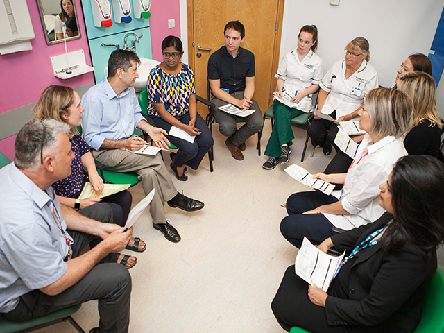 A team of professionals sitting in a circle talking