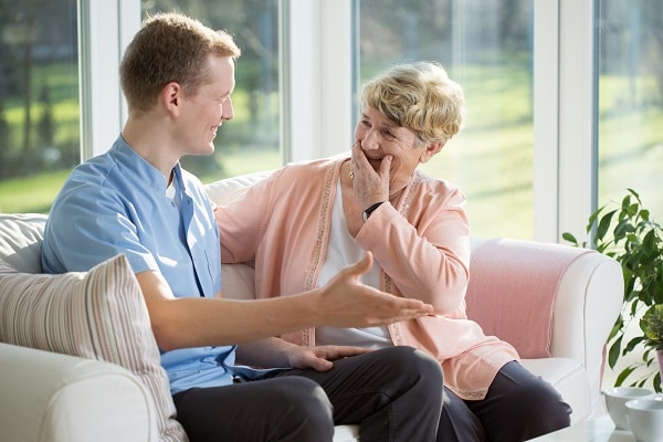 Man talking to woman in a conservatory