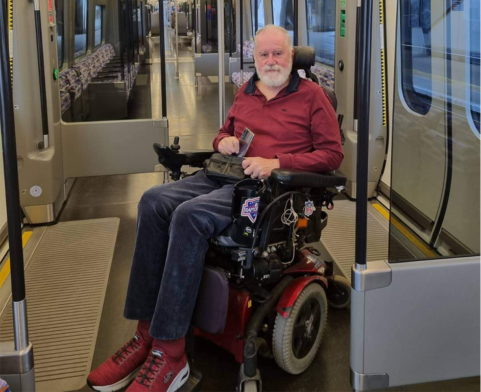 person in wheelchair on train