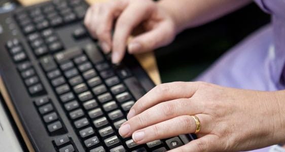 Hands typing on a keyboard