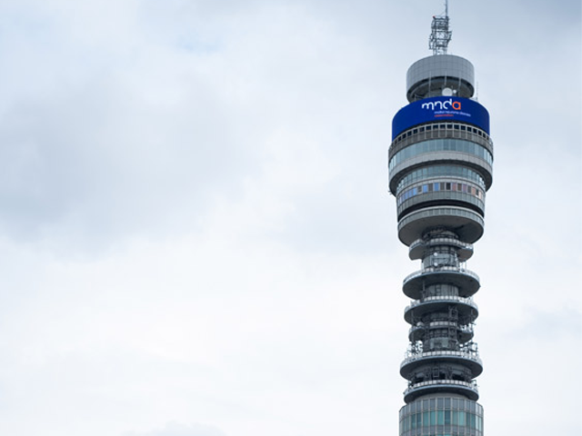 Image of the BT Tower in London with a MNDA Flag attached.