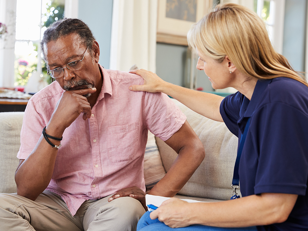 healthcare professional supporting someone in deep thought 