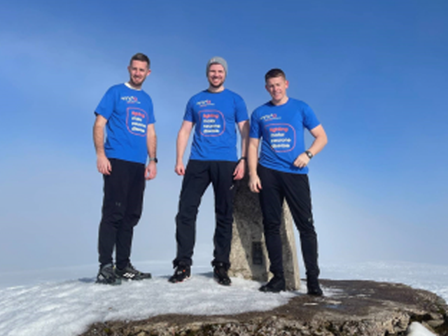 three people standing on the top of a mountain with snow 