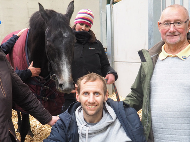 Photo of Rob Burrow and family in a horse stable