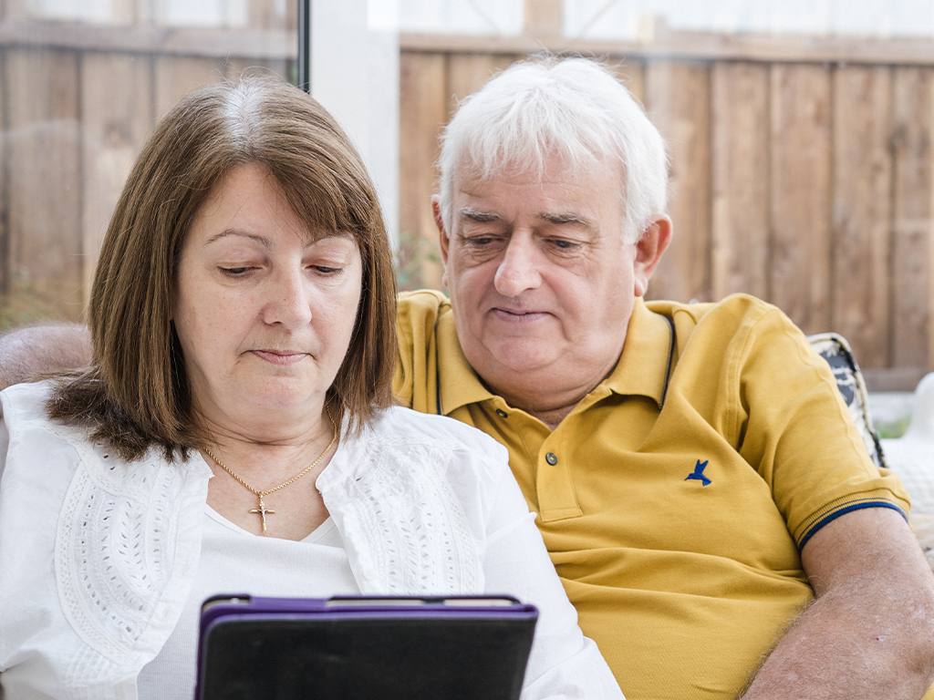 two people looking at a device