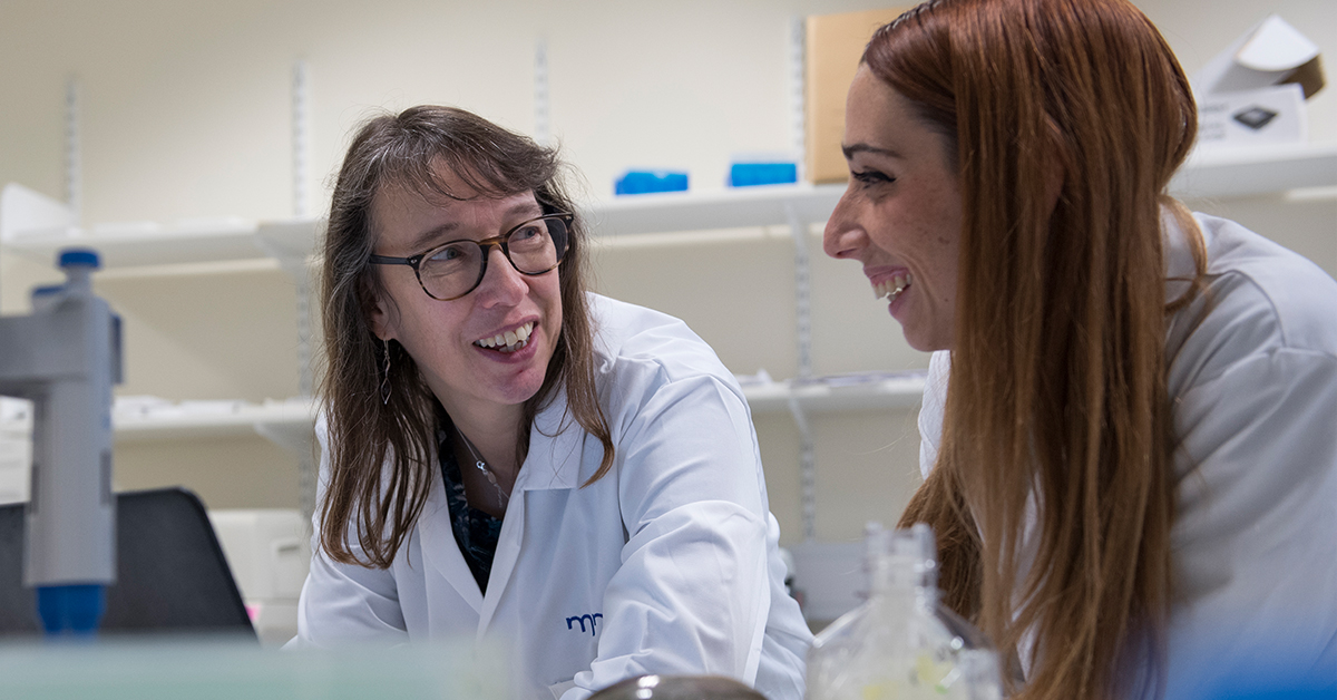 Professor Janine Kirby and colleague looking at research in the lab