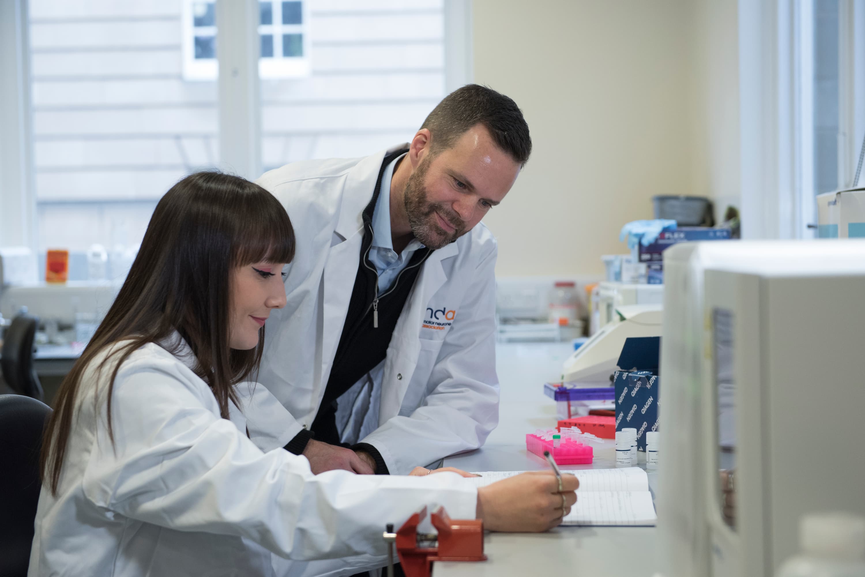 Gareth Miles and colleague in the lab, looking at notes
