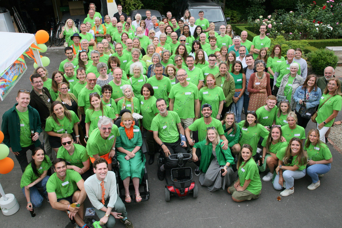 Susan Fletcher Watts and team in green shirts fundraising