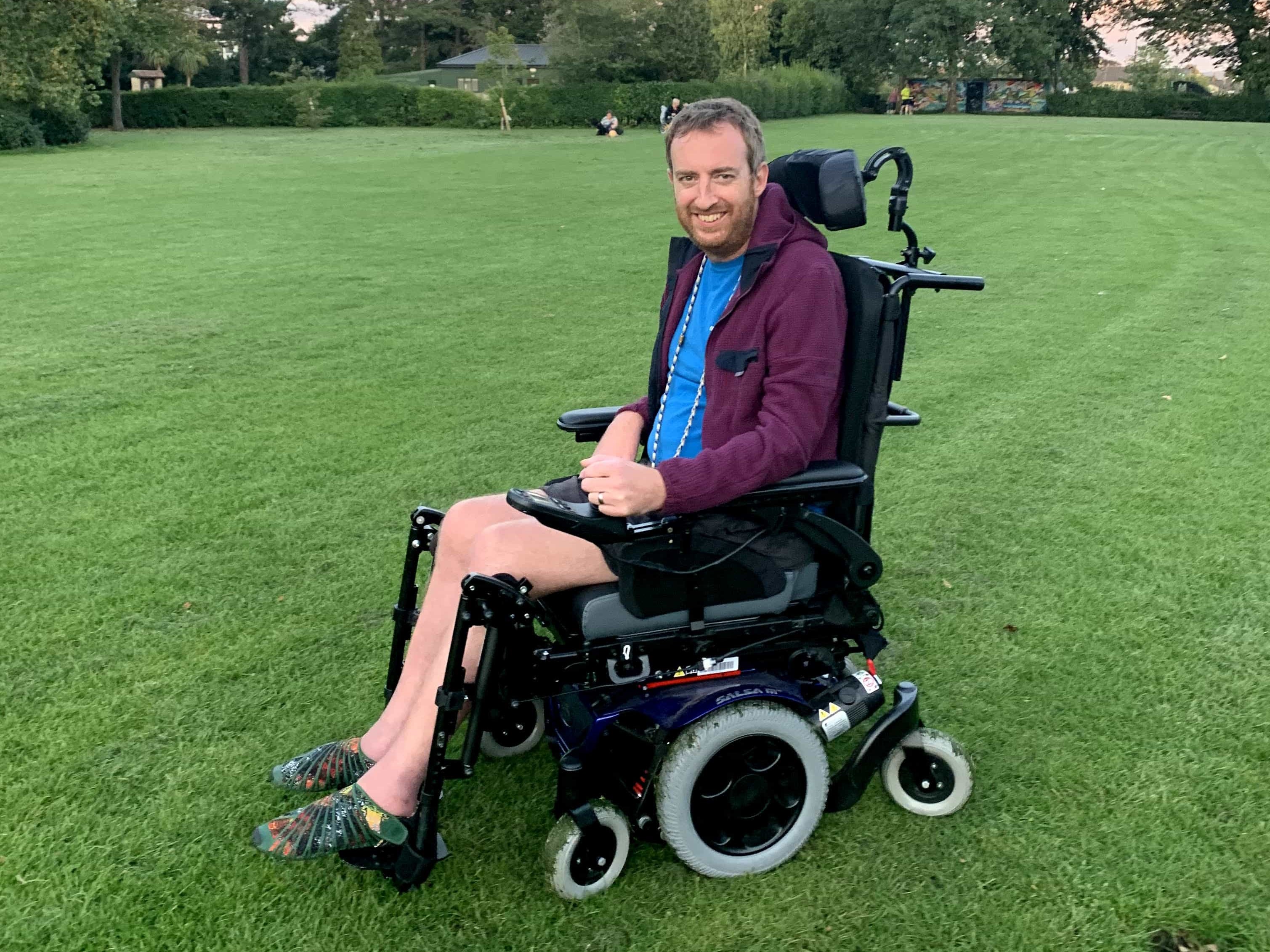 Alex in a wheelchair, at a park