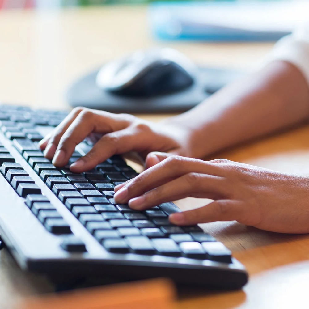 a person typing on a computer keyboard