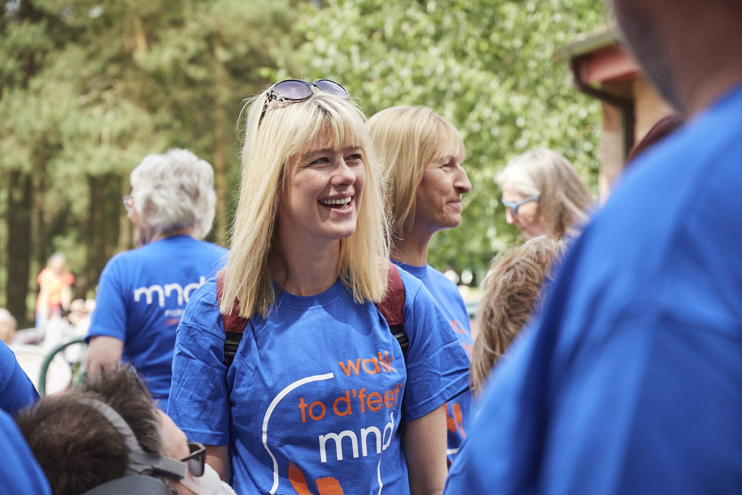 a group of people wearing mnd association t-shirts