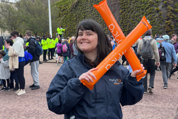 a person wearing a mnd association branded jacket