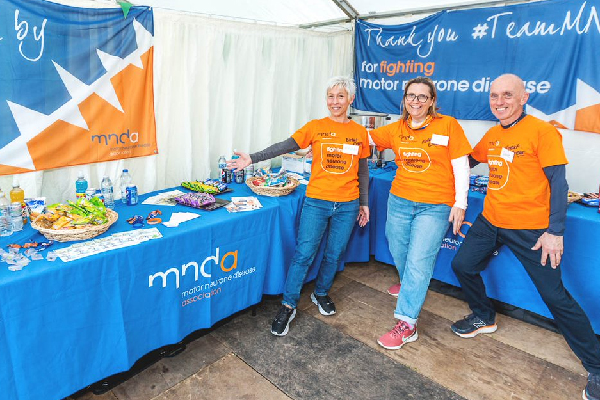 a group of people wearing mnd association t-shirts