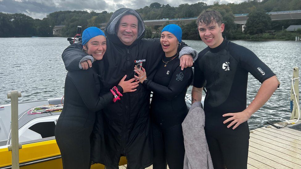 Mark O'Brien stood alongside his children beside the water he had completed his 6.8 mile swim