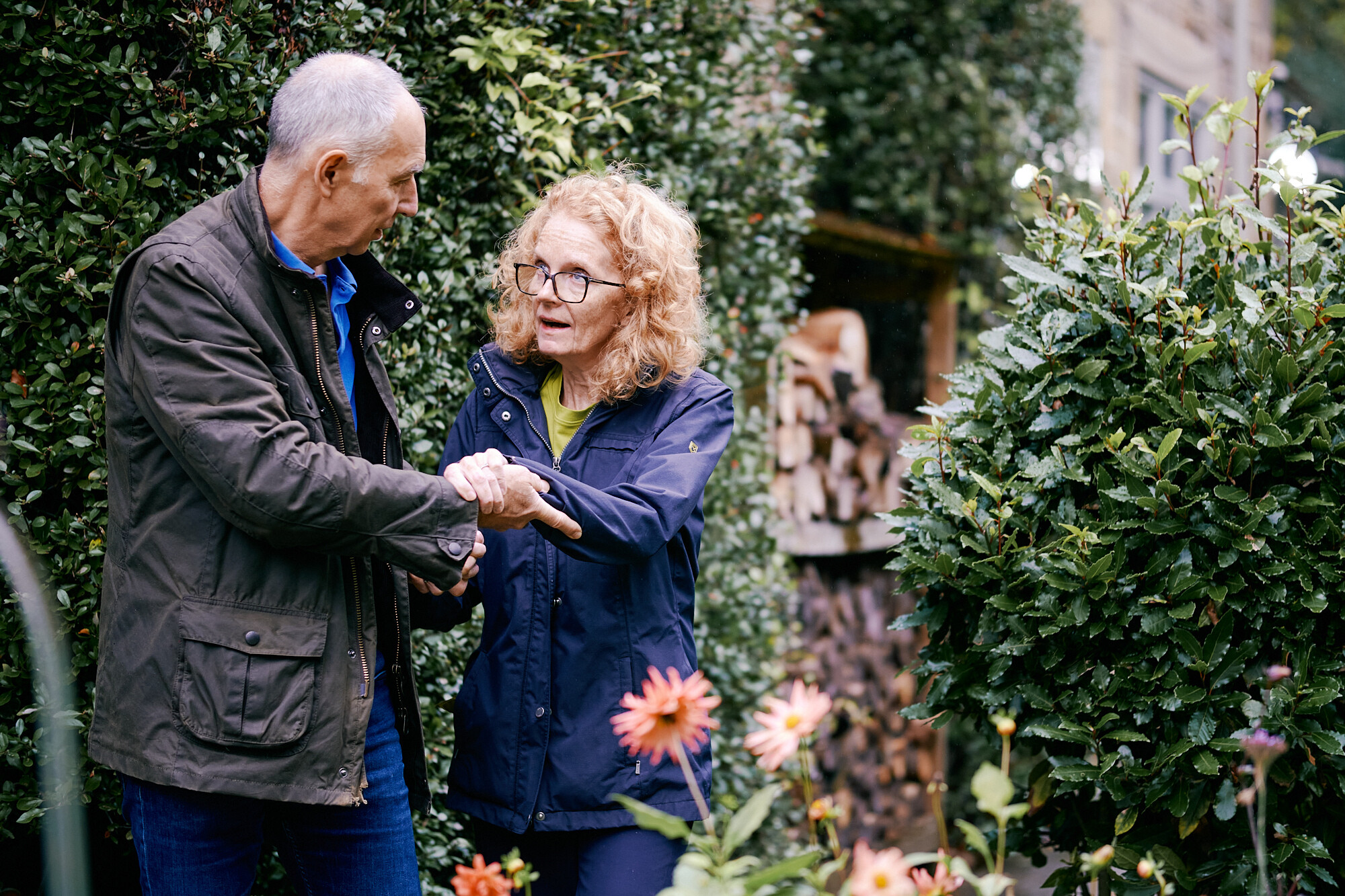 Louise, living with MND, and her partner Rob in the garden. 