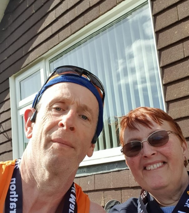 Two people smiling down at the camera 