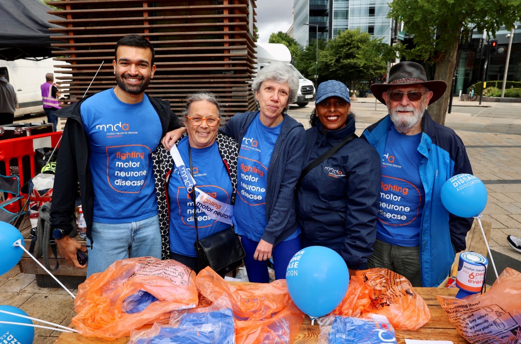 Volunteers standing behind fundraising table