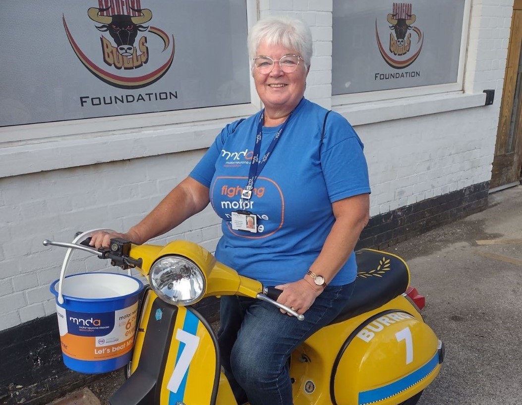 Tracy on a scooter raising money for MND