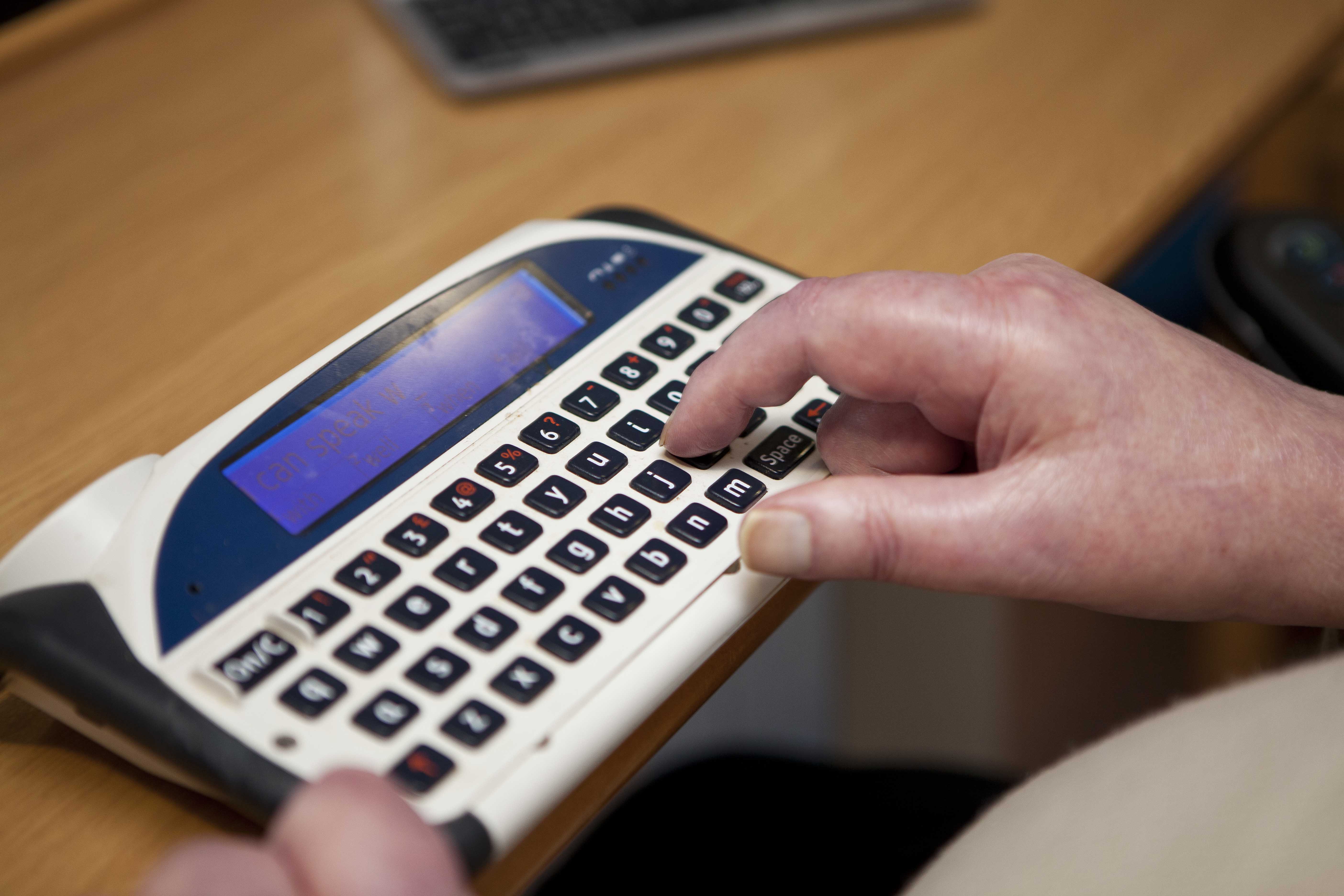 Someone typing on a lightwriter