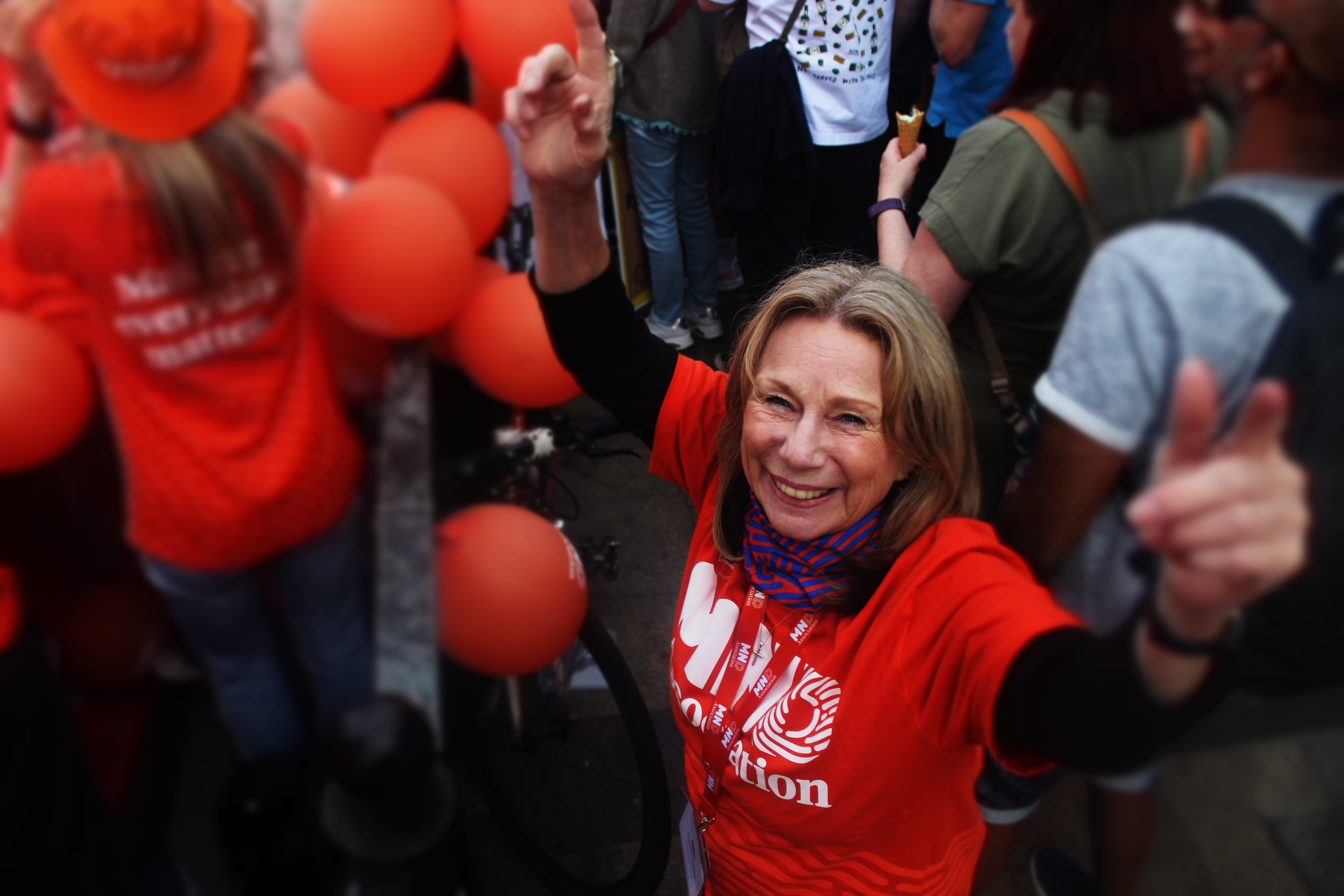 Volunteer smiling with thumbs up