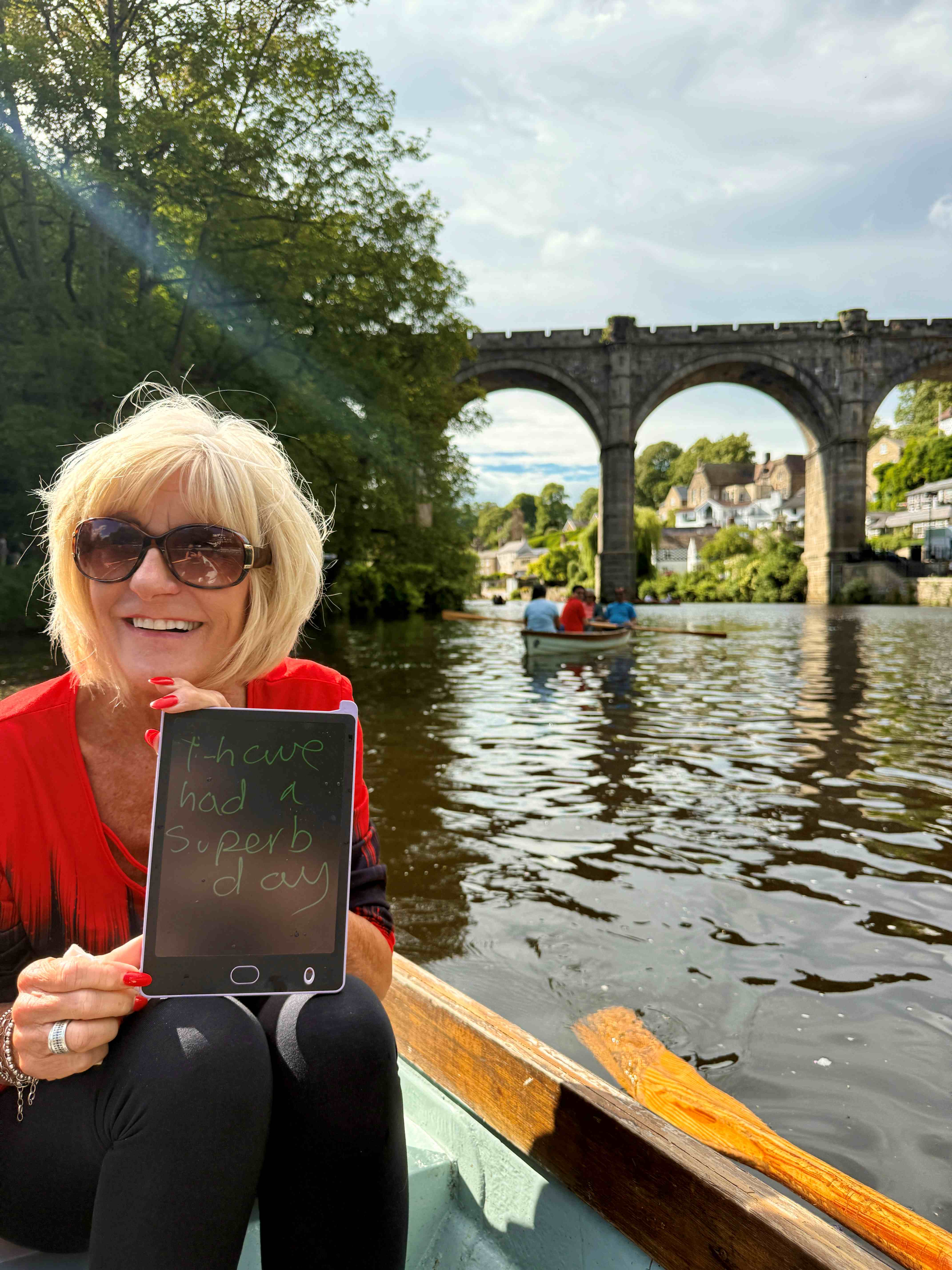 Hayley enjoying a day out, she writes "I'm having a splendid day" on her comms aid