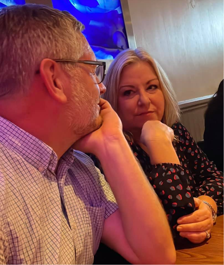 John and Julie look into each others eyes across the table
