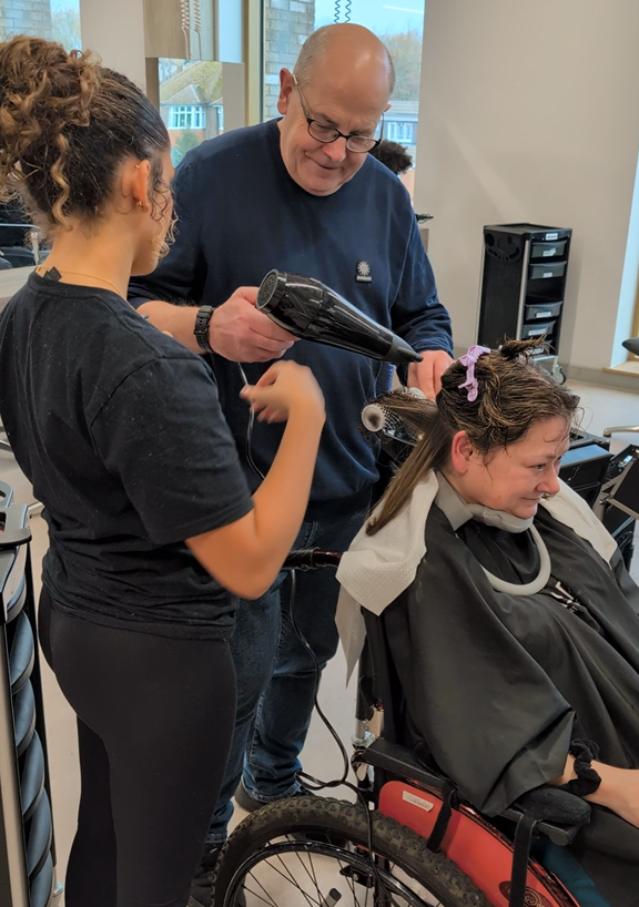 Matt learning how to blow dry Gill's hair.