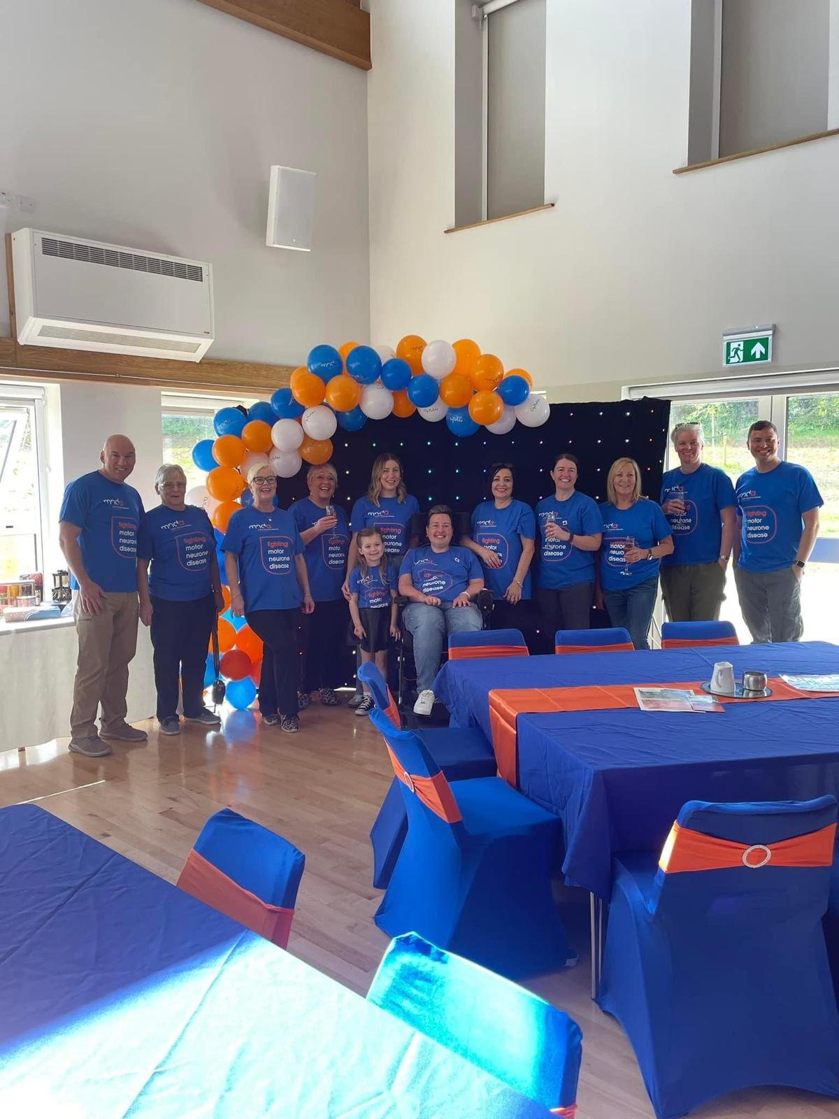 Volunteers smiling together with balloons at an event