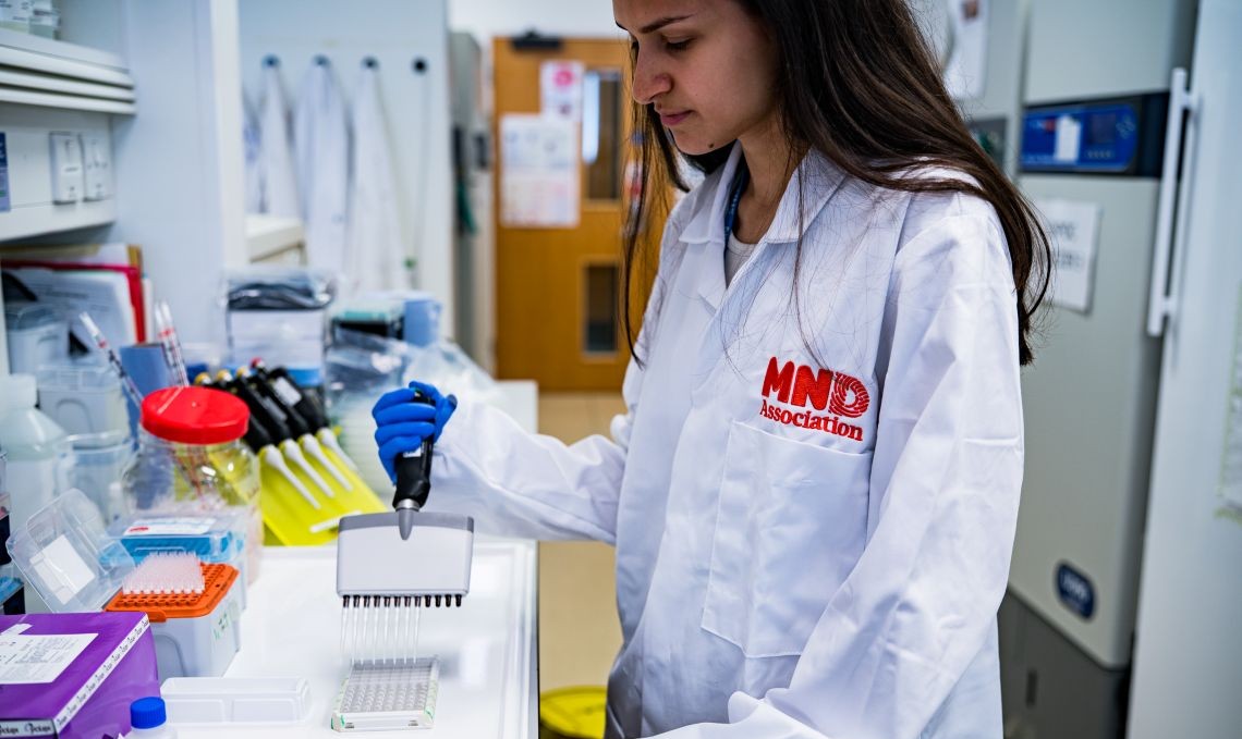 Scientist working in a research lab wearing an MND association lab coat.