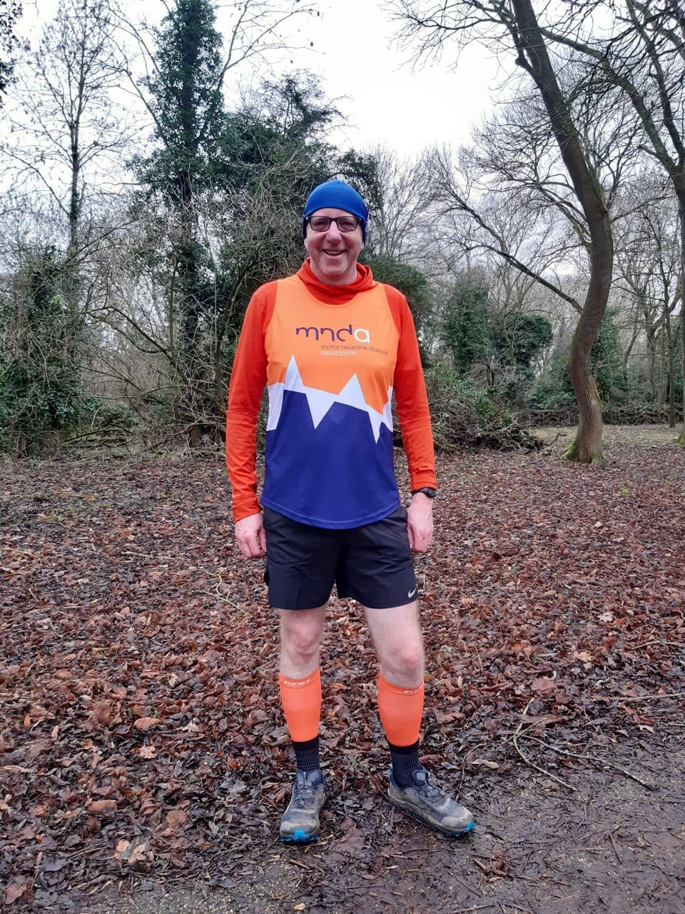 Grant stood with his MND Association branded running gear. 