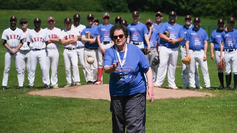Committee member Hetty throwing a baseball on the pitch