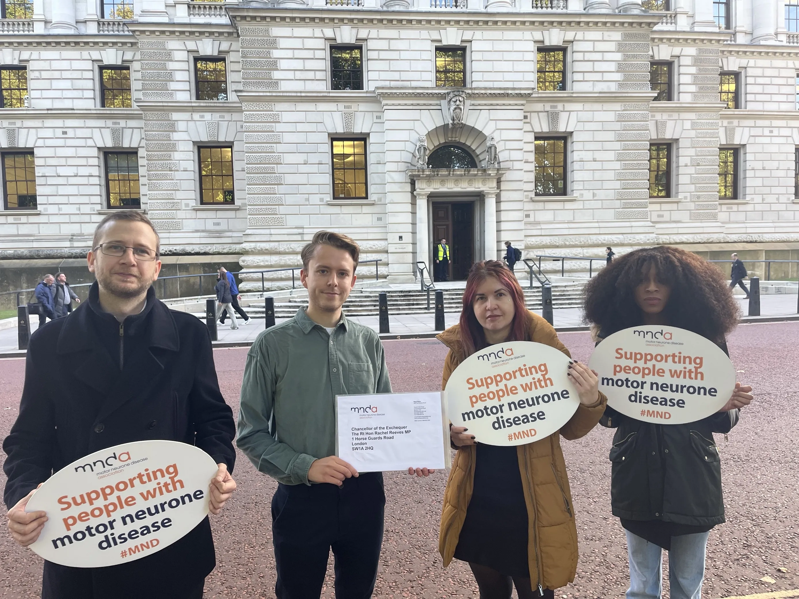 MND Association staff handing in the signed letter