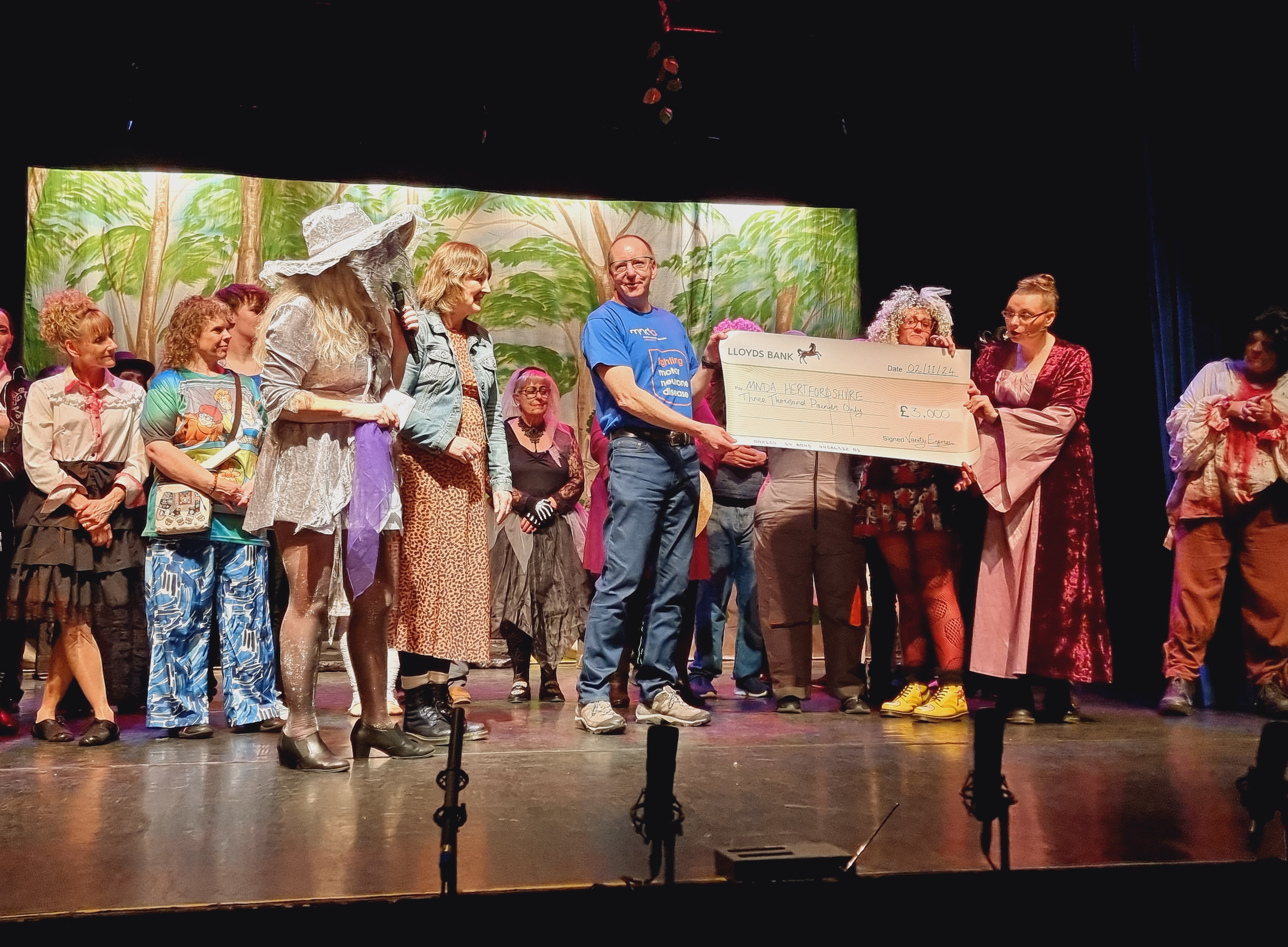 MNDA Hertfordshire volunteers presented with cheque by Variety Express on stage 