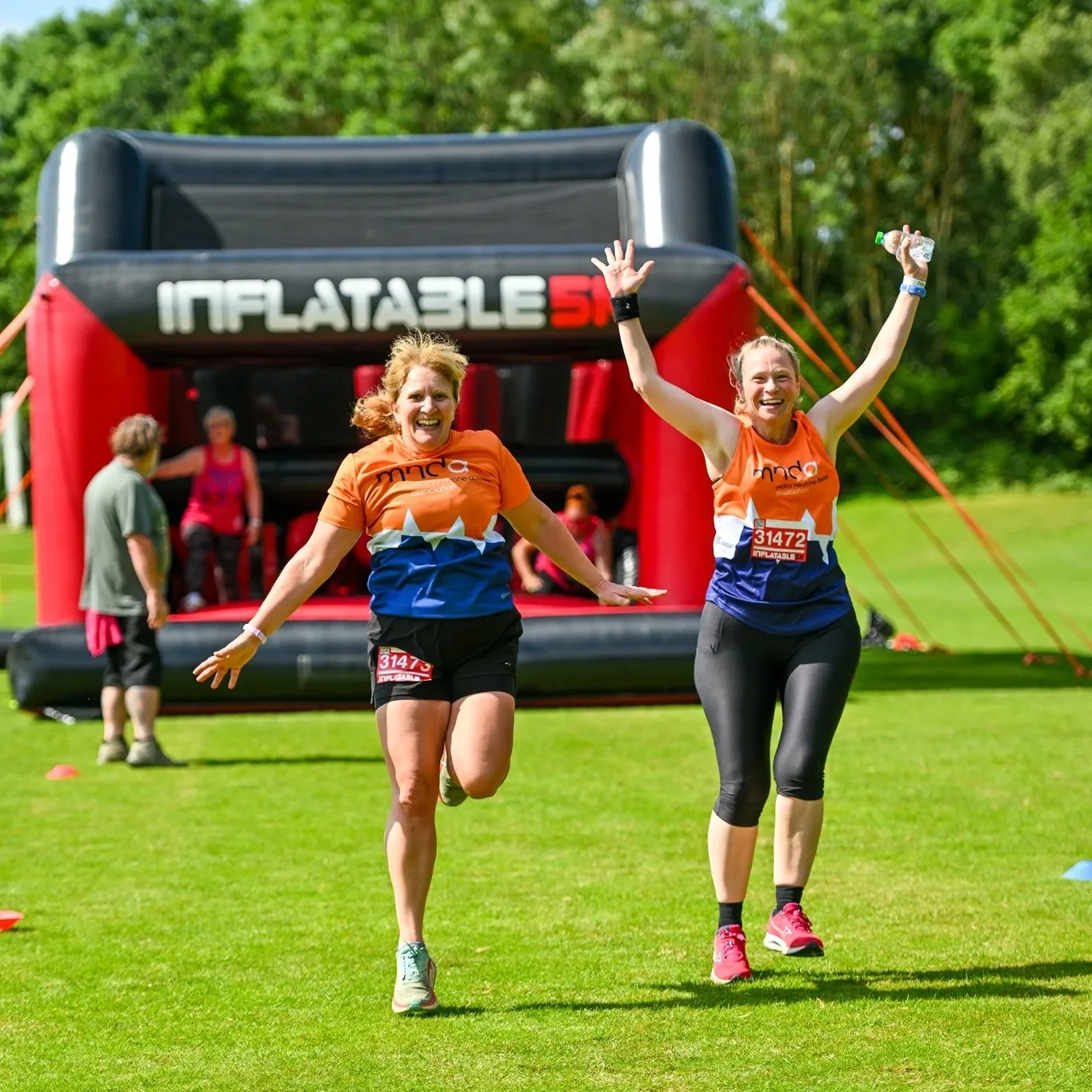 Paula and Heidi completing 5k inflatable obstacle course.