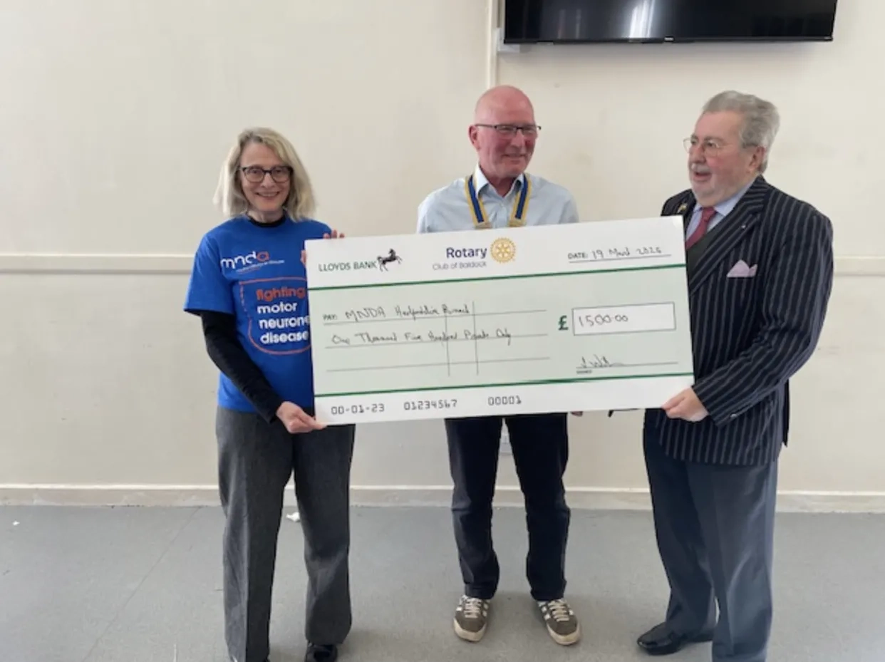 Lindsey, Garry and Keith stood holding a large check