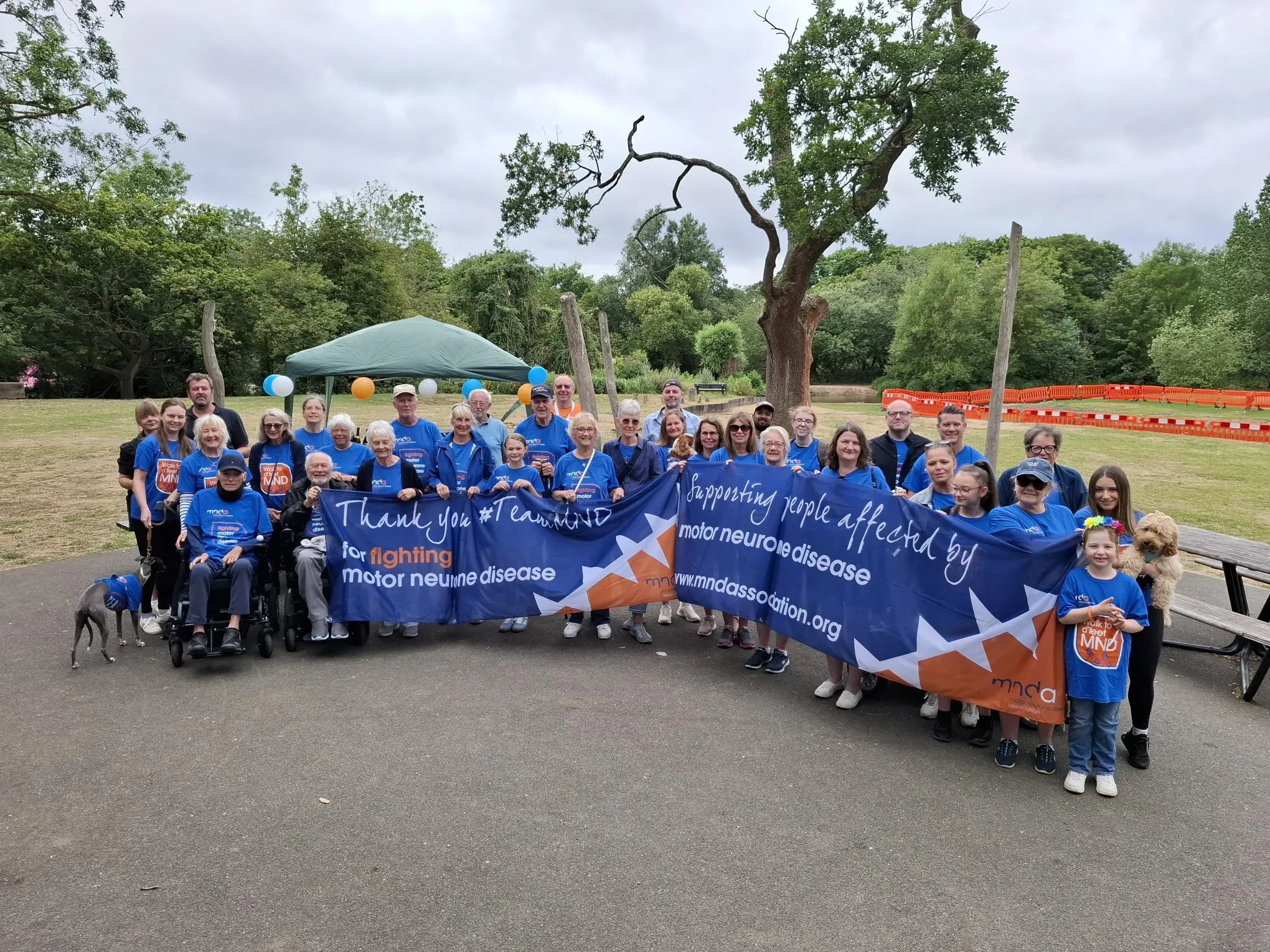 A group of MND Association supports wearing MNDA t shirts who have completed the Walk to D'feet at Stanborough lakes