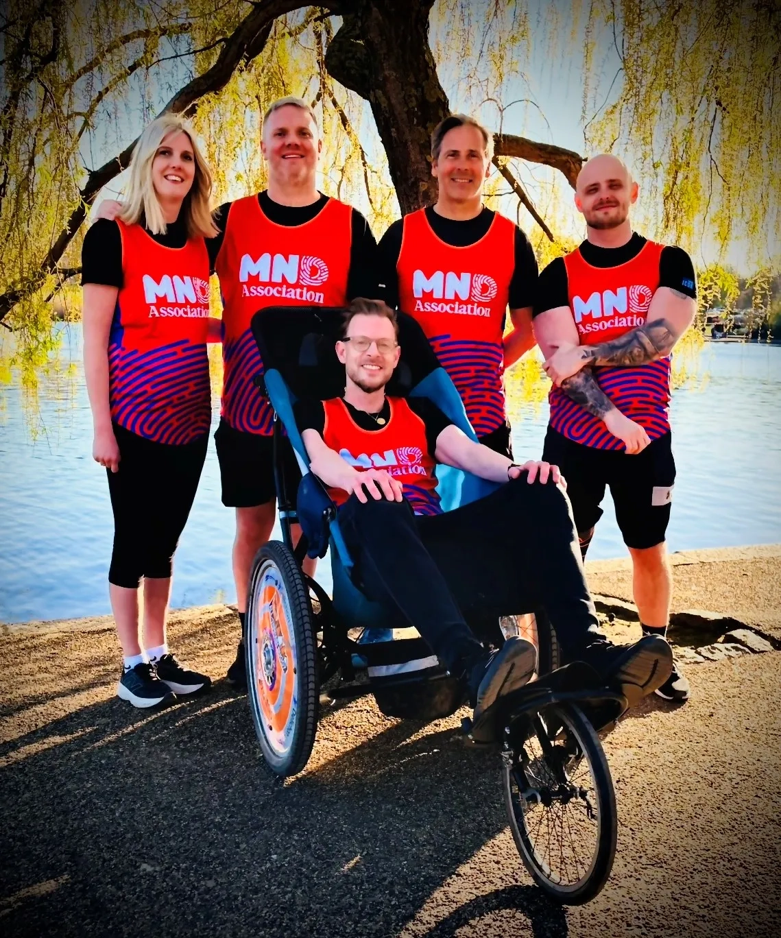 Matthew Cox who is taking part in the London Marathon pushed by members of his family