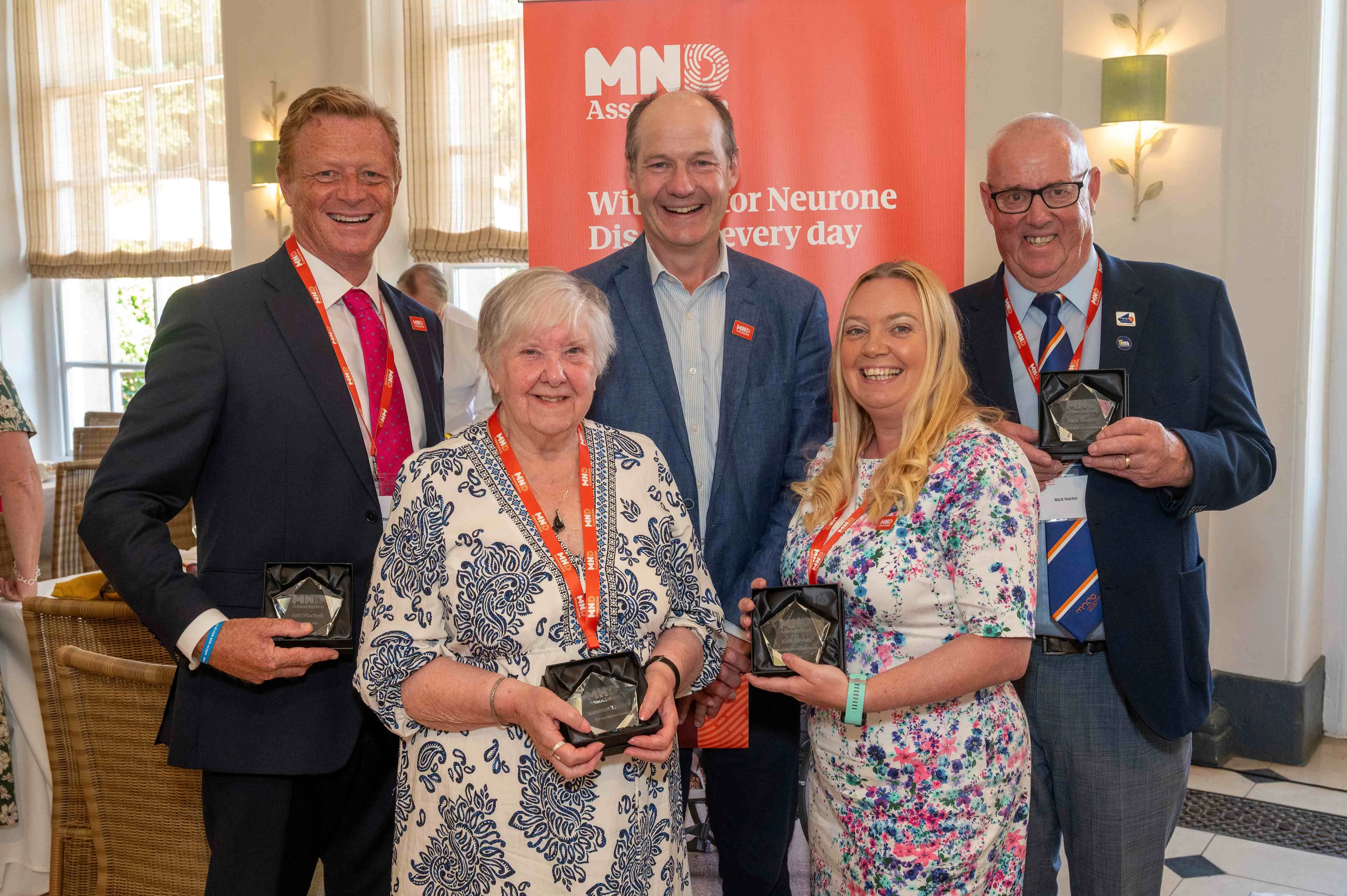 Four MND Association volunteers with Charlie Ireland